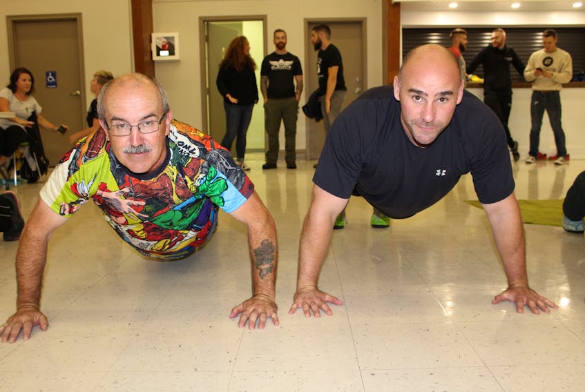 Bill Guiney (left) and Paul Fifield, manager of corporate services with the Canadian Mental Health Association of Newfoundland and Labrador, were among about 40 participants who took part in the 3rd annual Guiney Push Up Challenge at St. Kevin’s Parish Hall in Goulds on Wednesday
