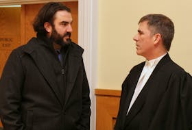 Reporter Justin Brake (left) speaks with his lawyer, Geoff Budden, during a break in proceedings at Supreme Court of Newfoundland and Labrador Court of Appeal in St. John’s Tuesday morning.