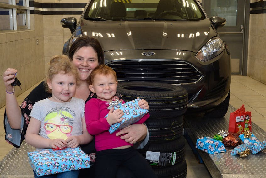 Sarah McNiven of St. John’s, with her children, Brianna, 5, and Natalie, 4, holds the keys to her new vehicle at Collision Clinic Ltd. on Topsail Road in St. John’s on Wednesday.