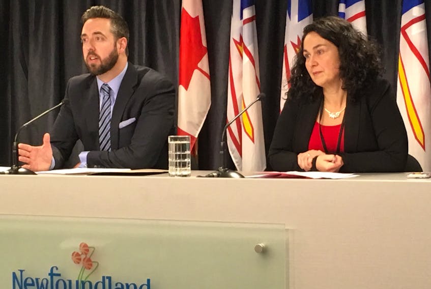 Justice Minister Andrew Parsons speaks to reporters in St. John’s Thursday as Kendra Wright, assistant deputy minister of courts and corporate services, looks on.