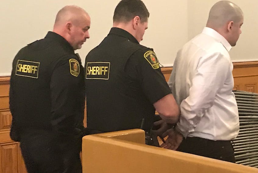 Sheriff’s officers place handcuffs on Graham Veitch before escorting him to the lockup after his murder trial adjourned Thursday.