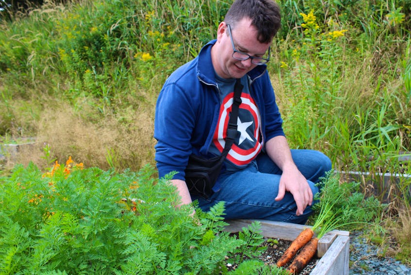 Robert Kenny benefits from the gardening-based programs at the Autism Society of Newfoundland and Labrador. As a seasonal grounds assistant, he helped to grow these carrots.
