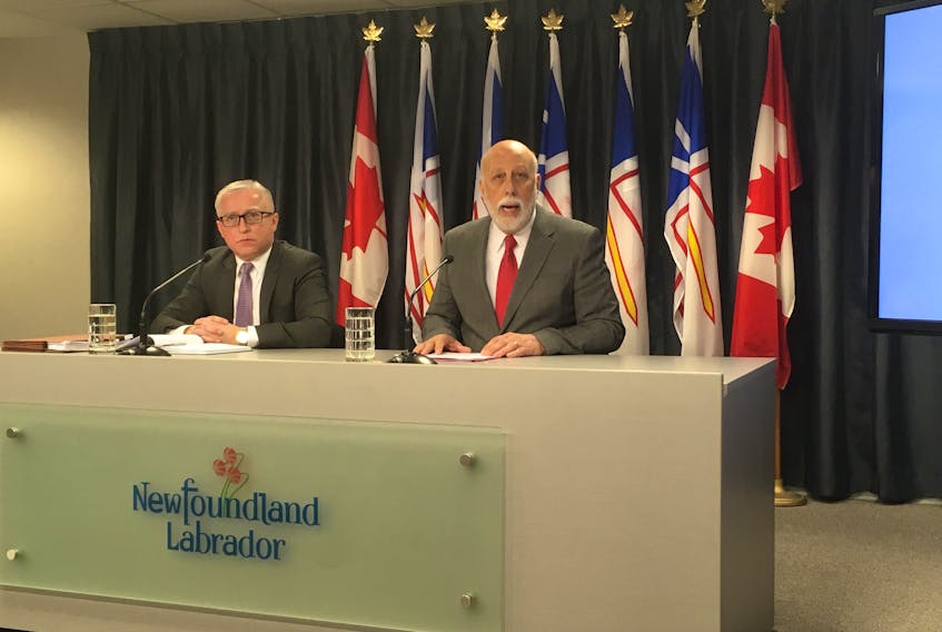 Advanced Education, Skills and Labour Minister Al Hawkins (right) takes questions on the province’s handling of minimum wage at the Confederation Building Media Centre on Tuesday. Hawkins was joined by director of the labour standards division, Ken Clements.