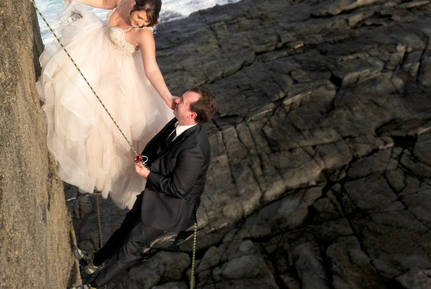 Newlyweds Mandy and Steve O’Keefe garnered plenty of attention when their photos of the bride and groom repelling down a cliff in Flatrock were recently posted on social media.