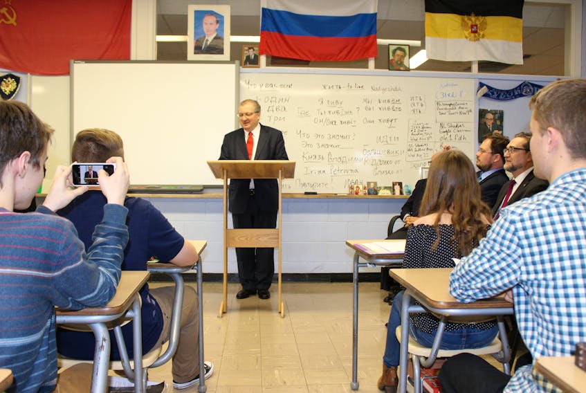 A student takes a photo as Alexander Darchiev, Russia’s ambassador to Canada, speaks to students at Prince of Wales Collegiate Thursday in St. John’s.