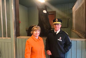 Lisa Brown, Stella’s Circle CEO, and Chief Joe Boland of the Royal Newfoundland Constabulary pose Tuesday with Mr. Rich, one of the RNC mounted division’s horses. The two groups, along with the Avalon Equestrian Centre in Conception Bay South, have completed a six-week program, a combined initiative to help participants deal with many forms of mental-health issues.