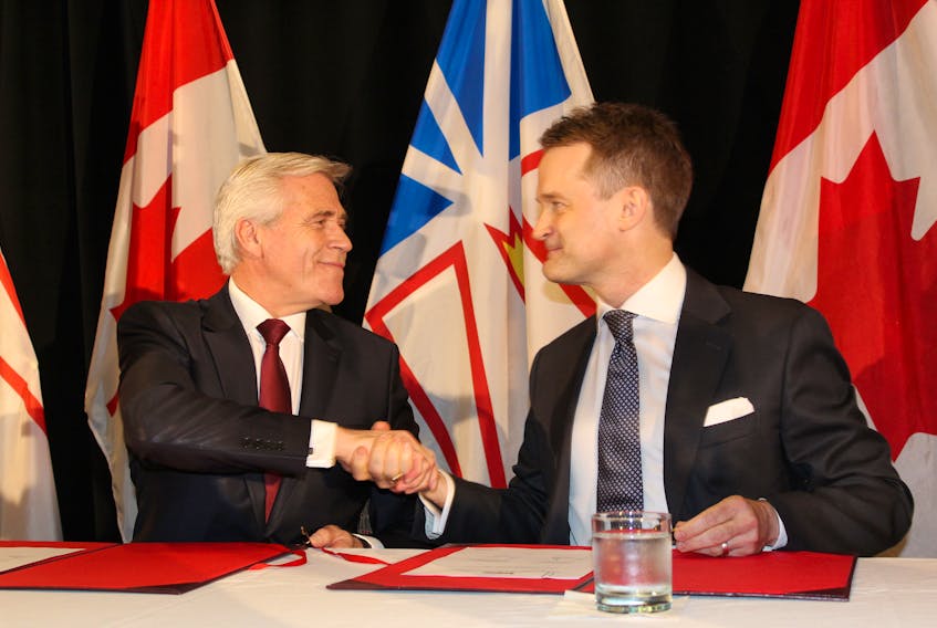 Premier Dwight Ball and federal cabinet minister Seamus O’Regan shake hands after signing the renegotiated 2019 Atlantic Accord review Monday at the Sheraton Hotel Newfoundland in St. John’s.