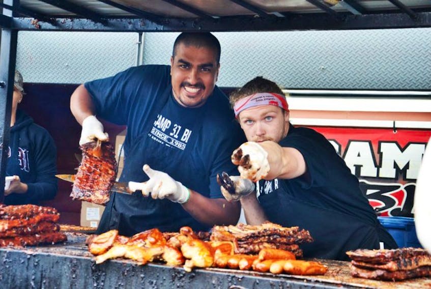 Mitchell Russell from the Camp 31 rib team, one of three confirmed groups for the inaugural St. John’s Ribfest, showed the crowd what was in store for them as they waited in line at the Sydney Ribfest in 2017.