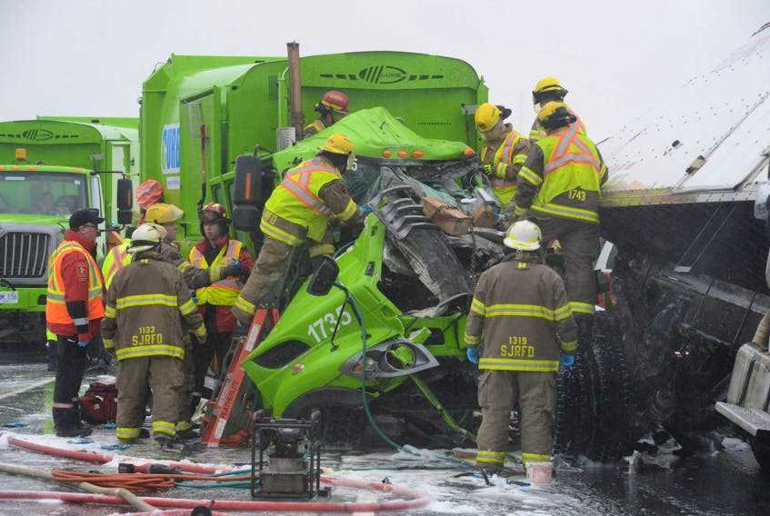 Veteran Telegram photographer Joe Gibbons took this photo in October 2018 of firefighters and paramedics working to free a City of St. John’s garbage truck driver from his vehicle after a collision on the Outer Ring Road.