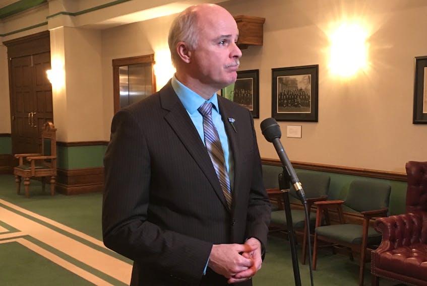 Outside of the House of Assembly Monday, Tom Osborne takes questions from reporters about paying for the plan to get severance liability off the province’s books.