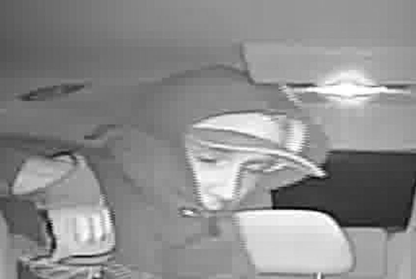 A man suspected of attempting to rob a taxi driver Tuesday morning is shown in a still image taken from the CCTV inside the taxi.