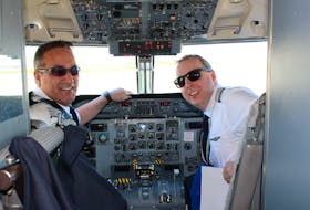 Capt. Kirby Short and Lt. Todd Coates smile in the cockpit of a Dash 8 PAL Airlines plane, which made a commemorative flight over St. John’s and The Narrows on Friday, retracing the flight plan of Capt. John Alcock and Lt. Arthur Whitten Brown, who made the first non-stop transatlantic flight on June 14, 1919.