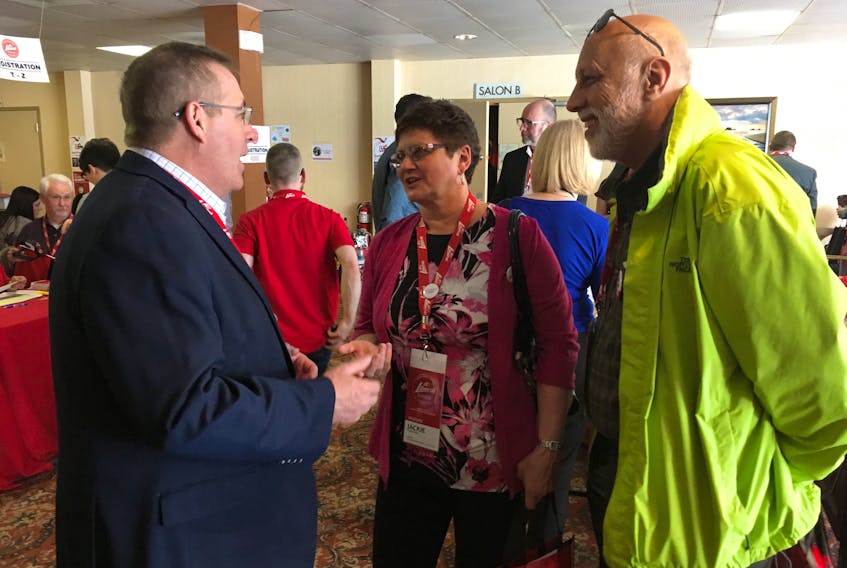 Minister of Transportation and Works Steve Crocker (left), Education Minister Al Hawkins (right) and Liberal convention delegate Jackie Watkins chat Friday in the Quality Hotel and Suites in Gander at the start of the Liberal general meeting and conference.