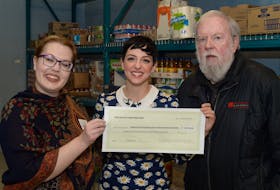 “Come From Away” cast member Steffi D. (centre) and Abra Whitney, interim general manager of Opera On the Avalon, present a cheque to Eg Walters, general manager of the Community Food Sharing Association.