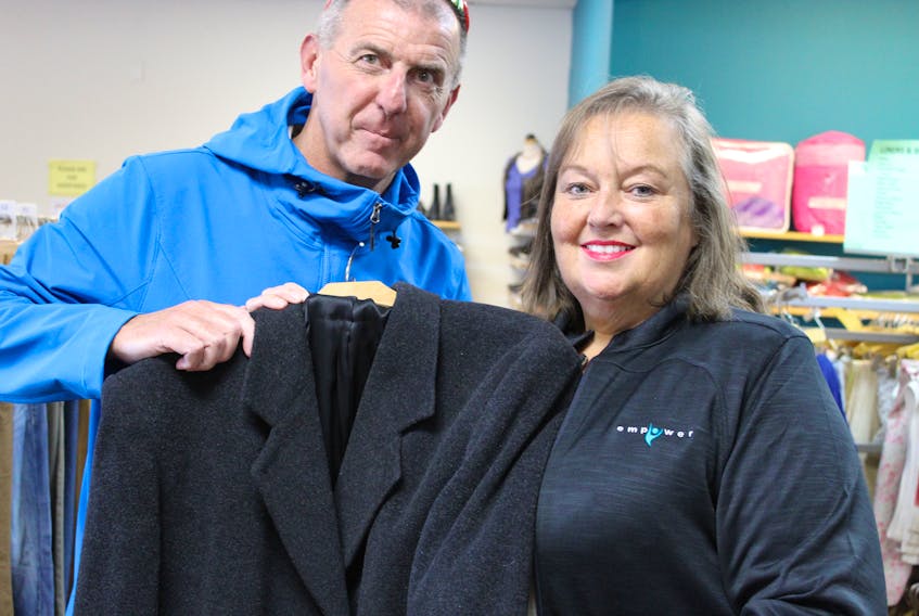 Kimberly Yetman Dawson (right), executive director of Empower, The Disability Resource Centre, the organization that operates Take Two Gently and Used Clothing in Ropewalk Lane Plaza, shows The Telegram’s Sam McNeish a new-to-him winter coat available at the location. Take Two, The Telegram and UPS are joining forces on Saturday to collect clothing and household items in the A1E postal code area of St. John’s.