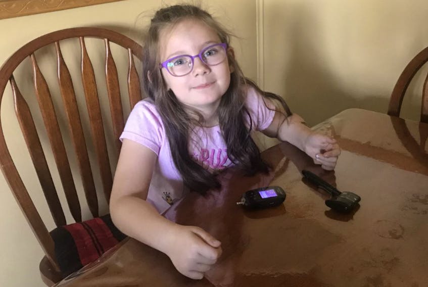 Madison Porter, daughter of Cindy Greenslade, checks her blood sugars. This is a routine she repeats several times daily.