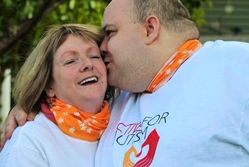Douglas Dunne kisses his mother, Clara, following the Active for Autism Walk held in Renews in 2017.