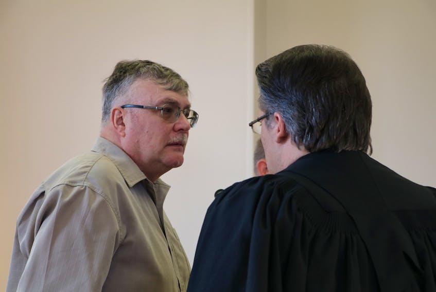 Douglas Noseworthy speaks to his lawyer, Mark Gruchy, in Newfoundland and Labrador Supreme Court in St. John’s following his sentencing hearing Tuesday. Noseworthy was sent to prison for 15 months for possession of child pornography.