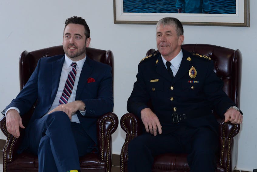 Justice Minister Andrew Parsons (left) and RNC Chief of Police Joe Boland await the start of proceedings on Thursday in the RNC provincial headquarters at Fort Townshend, where the RNC’s corporate plan — “Building Safe and Healthy Communities Together” — for 2018-21 was released.