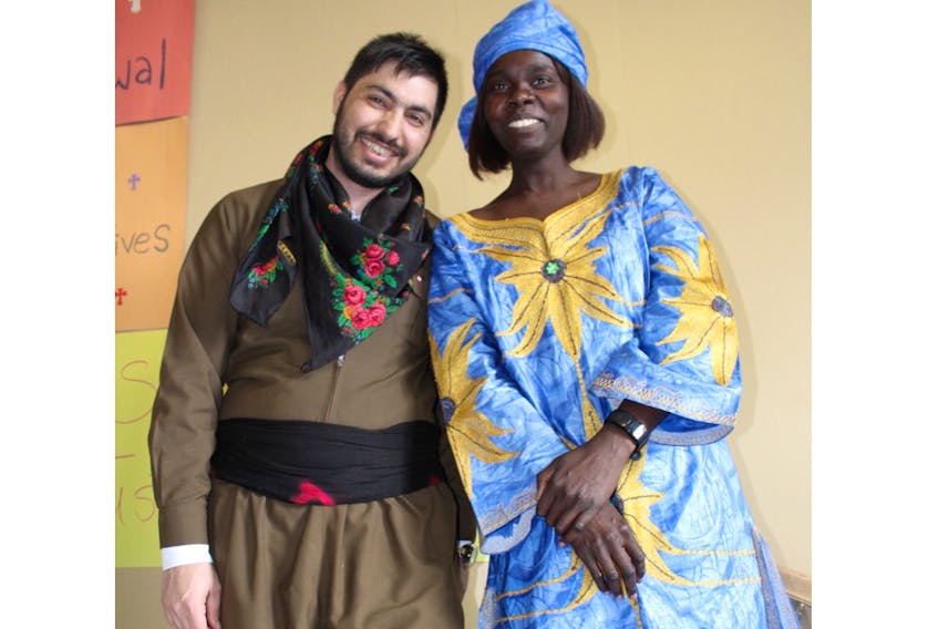 Roni Ibrahim, from Syria, and Einam Mohamadain, from Sudan, at the Pius X Church Hall on Wednesday for the Multiculturalism Week Global Tour.
