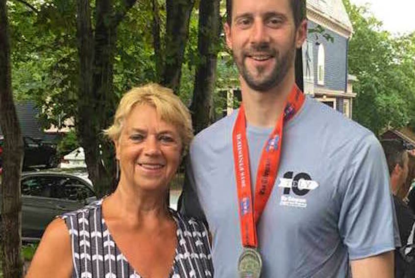 Cynthia Oliver of Burnt Point came to St. John’s Sunday to see her son, Trevor Harris, participate in the Tely 10 road race. He surprised her at the halfway point of the race by running up to her to give her a birthday card.