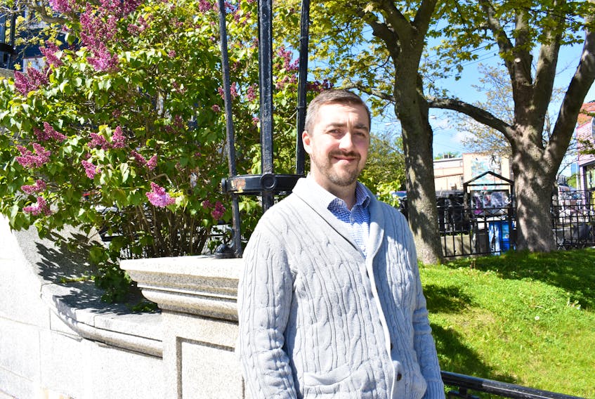 Joshua Smee, chair of the board of directors for the St. John’s Farmer’s Market Co-operative, enjoys the sun at the War Memorial on Duckworth Street.