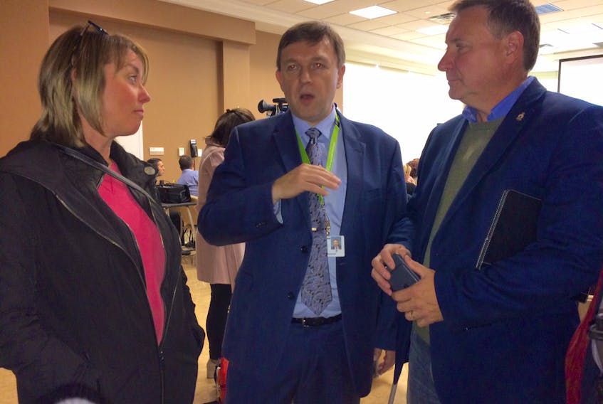 Eastern Health president and CEO David Diamond (centre) chats with Portugal Cove-St. Philip's Coun. Tina Neary and Conception Bay East-Bell Island MHA David Brazil Thursday about the ongoing concerns regarding the community services clinic in the town.