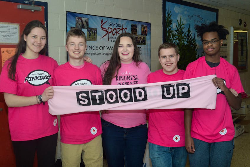 Lynelle Cantwell (centre) with members of Prince of Wales Collegiate’s  Beyond the Hurt  group, which promotes anti-bullying, at the St. John’s school on Wednesday. Pictured are (from left) Rachel Harpur, Toby Robinson, Cantwell, Michael Reader and Nibras Birama. They are holding the group’s Stood Up to bullying banner.