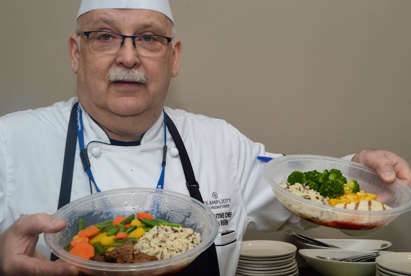 Chef Tim Hills serves several of the dishes he prepared for the Steamplicity food delivery service for acute care hospitals announcement Thursday.
