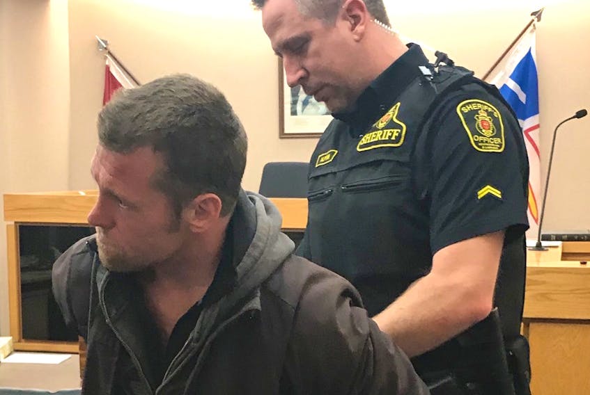 Richard Rees, 36, is handcuffed and escorted from a St. John's courtroom by a sheriff Friday morning to begin serving a three-month sentence for sexual interference.