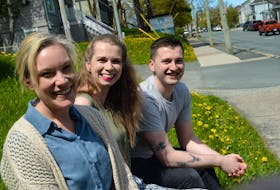 From left, Erin Butler, Ellie Jones and Aaron Patey of Thrive sit outside their LeMarchant Road office on Friday afternoon.