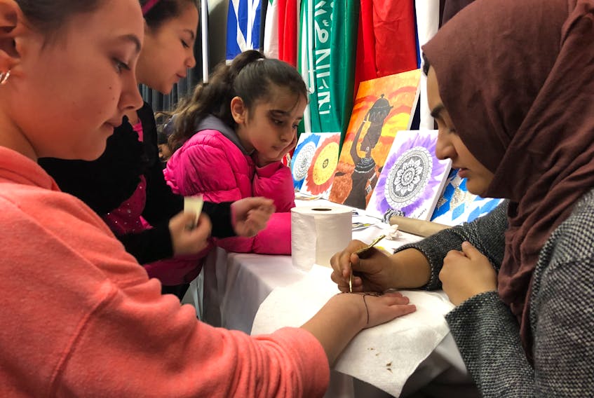 Raahyma Ahmad applies henna tattoos at the multicultural festival at the MacMorran Community Centre in St. John’s on Thursday.