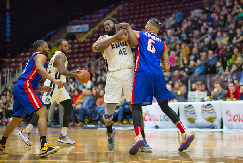Jeff Parsons/St. John’s Edge - Olu Ashaolu of the St. John’s Edge gets tangled up with the Cape Breton Highlanders’ Landon Atterberry in front of ball carrier and Edge teammate Junior Cadougan during NBL Canada play Sunday afternoon at Mile One Centre. The Edge won the game 105-84.