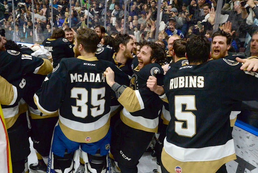 Members of the Newfoundland Growlers celebrate after winning the Kelly Cup at Mile One Centre.
