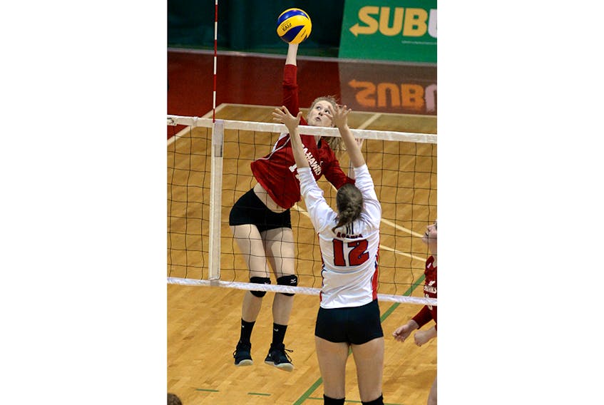 Catherine Smith of the Memorial Sea-Hawks spikes the ball over Acadia Axewomen player Lucy Glen-Carter during AUS volleyball action at the MUN Field House Sunday afternoon.