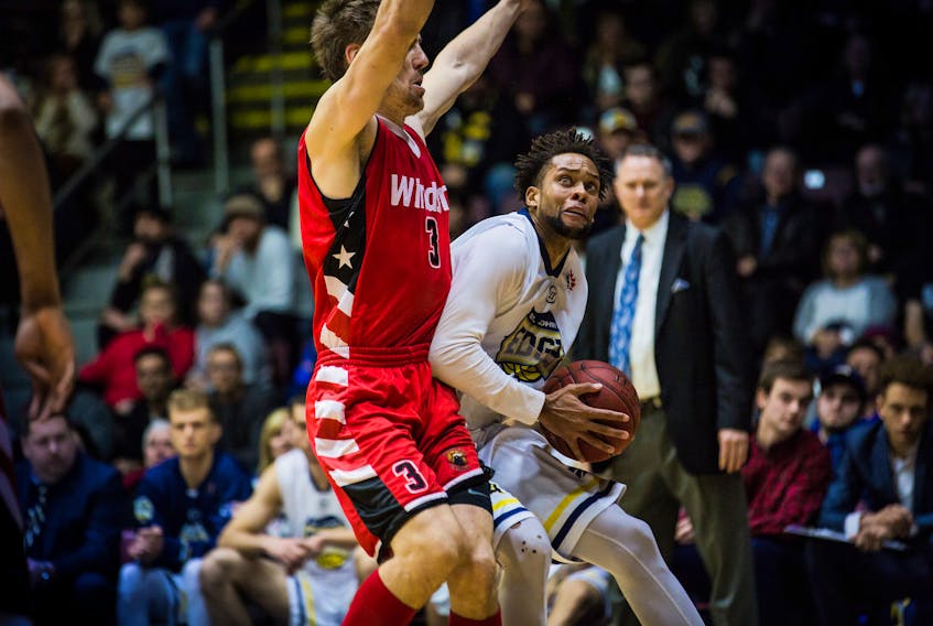 Charles Hinkle of the St. John’s Edge tries to drive past Logan Stutz (left) of the Windsor Express during a National Basketball League of Canada game at Mile One Centre earlier this season as St. John’s head coach Jeff Dunlap looks on in the background. How the Edge match up against Windsor’s big men like Stutz will be key as St. John’s enters its first-ever playoff series. Game 1 of a best-of-seven divisional semifinal against the Express goes 7 p.m. today at Mile One. — St. John’s Edge photo/Jeff Parsons