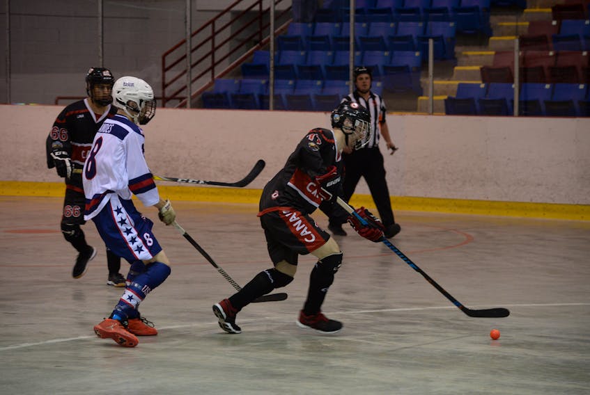 Canada’s Brent Broaders (right), heads up the rink with the ball as he is trailed by the United States’ Michael Andes (8) during their preliminary-round game Thursday morning at the Mount Pearl Glacier. Looking on is Canada’s Bryce Osepchuk (66). Broaders, who is from Fogo island, had a part in all of Canada’s scoring, with four goals and two assists in a 6-5 win. Overall, Broaders has 11 points and leads the U18 division in scoring.