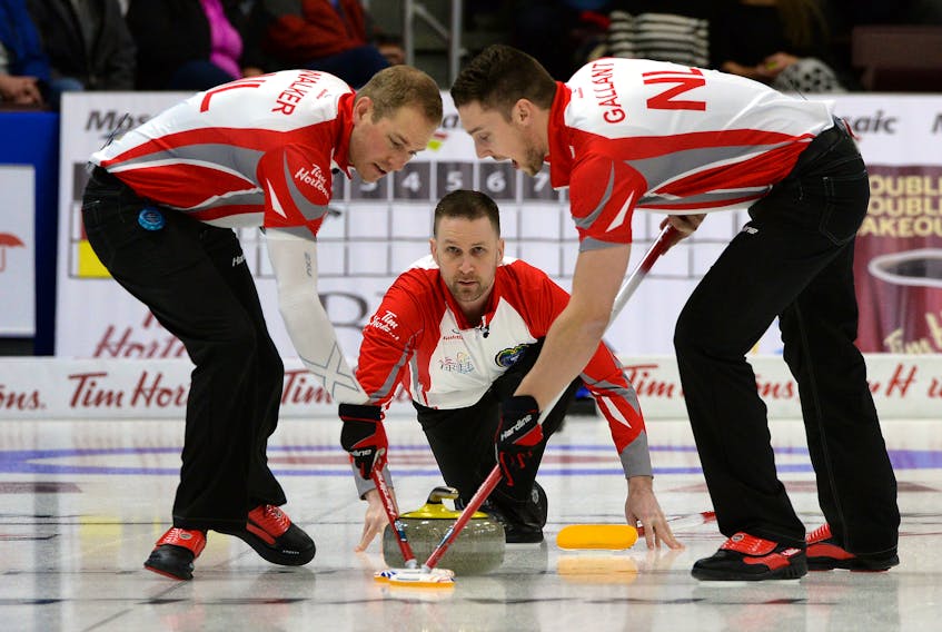 In this March 5, 2017 file photo, Newfoundland and Labrador skip Brad Gushue watches his shot as Geoff Walker and Brett Gallant sweep during play in the Brier at Mile One Centre in St. John’s. The Gushue rink has qualified for the Canadian Curling Trials next month in Ottawa, where Canada’s men’s and women’s curling entries for the 2018 Winter Olympics will be determined. Gushue, Gallant and Walker are also members of pairings that have berths in January playdowns to decide Canada’s first-ever Olympic mixed doubles team.