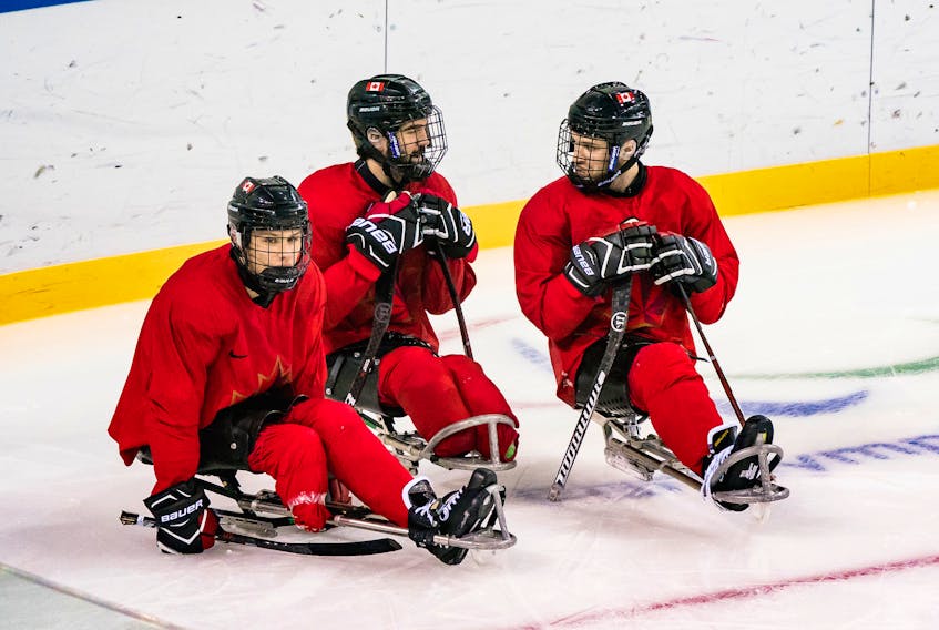 Liam Hickey (left) of St. John’s, along with team captain Greg Westlake and Tyler McGregor, are shown during a practice for Canada's sledge hockey team ahead of the start of competition at the 2018 Winter Paralympic Games in Pyeongchang, Korea. —  Dave Holland/Canadian Paralympic Committee