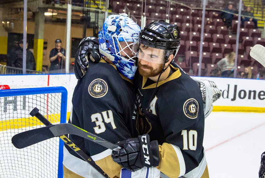 Zach O’Brien, shown here with teammate and Growlers goalie Michael Garteig, has scored a goal in each of his last six playoff games, including a hat trick in the series-clinching 5-1 win over the Manchester Monarchs Monday night. O’Brien is third in ECHL playoff scoring with 10 goals and 18 points.
