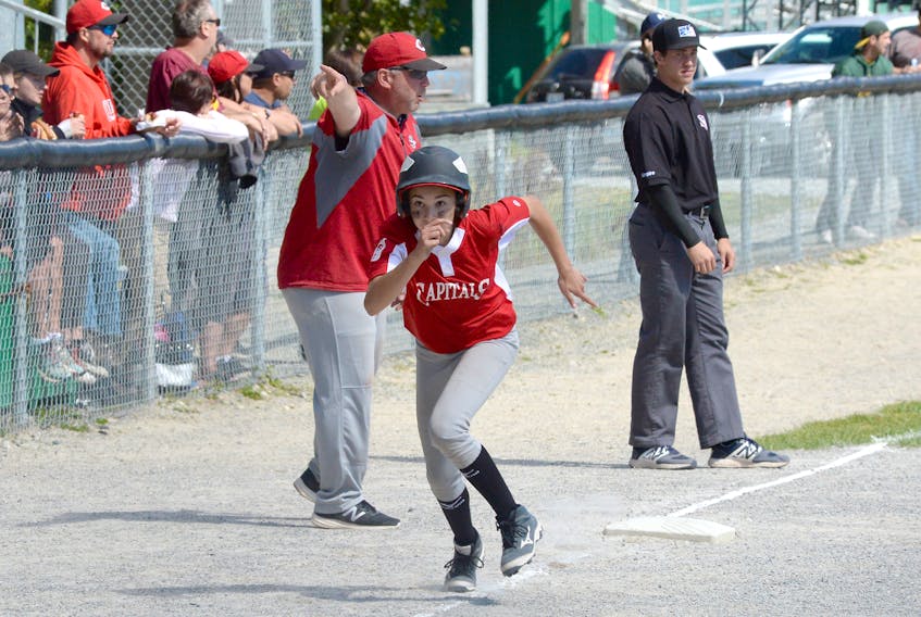 St. John’s Capitals baserunner Julia Chipman of the St. John’s Capitals is directed to home plate by coach Mark Healy during Sunday’s final of the Atlantic under-14 girls baseball championship at the Edgar Hartery Field, adjacent to St. Pat’s Ball Park in St. John’s