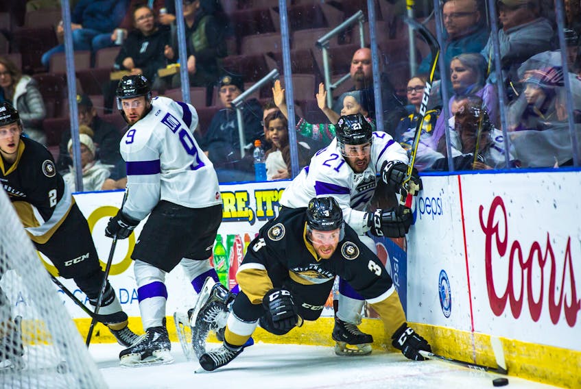 Newfoundland Growlers’ defenceman Rodi Short (3) dives for a puck as Brayden Low (9) and Fran DiChiara of the Reading Royals and Maxim Mizyurin of the Growlers look on during ECHL action at Mile One Centre Saturday night. — Newfoundland Growlers photo/Jeff Parsons