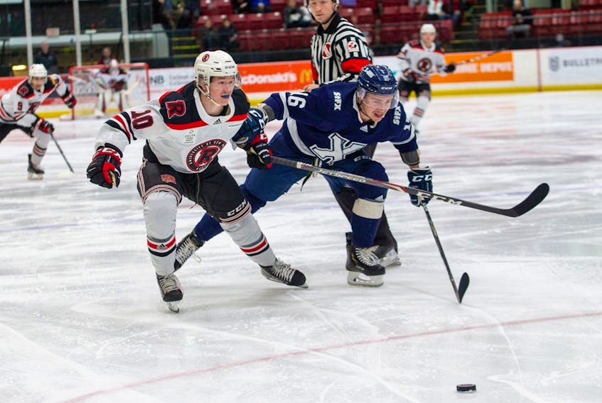 UNB’s Tyler Boland (10) and William Bower (16) of St. FX chase down a loose puck in AUS men’s hockey play earlier this season. Boland, the St. John’s native who leads No.1-ranked UNB in scoring, is part of a U Sports all-star team that will play two exhibition games against world junior hopefuls in Oakville, Ont. later this week. — UNB Athletics