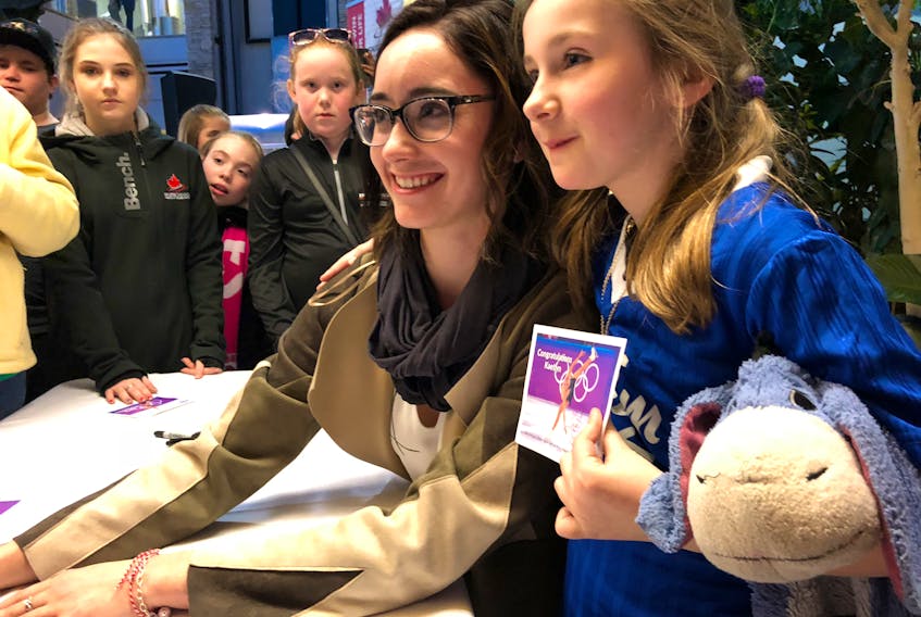 Fans, most of them young, stood in line to meet world figure skating champion Kaetlyn Osmond after she arrived at St. John’s International Airport Thursday night. Hero cards were handed out so they could get an autograph from the Marystown native. — Juanita Mercer/The Telegram