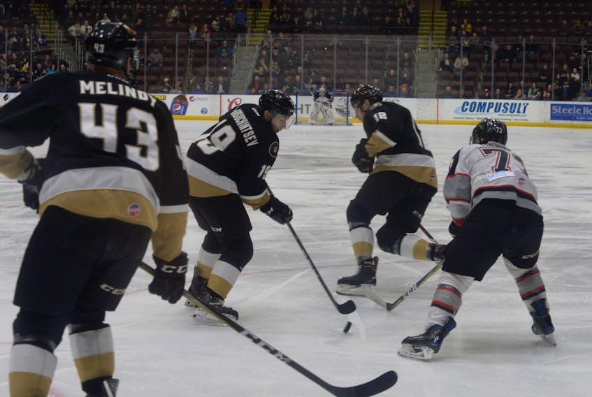 Semyon Der-Arguchintsev of the Newfoundland Growlers works to take control of the puck against Artur Tianulin (right) of the Brampton Beast during Game 2 of their first-round ECHL playoff series Saturday night at Mile One Centre. Growlers’ captain James Melindy looks on.