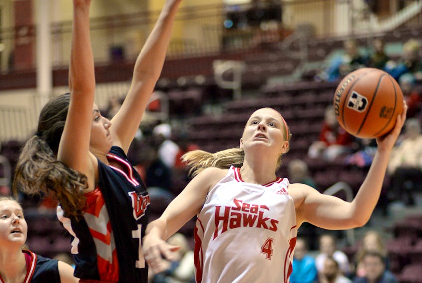 The Memorial Sea-Hawks’ Jane Baird (4) goes up for a shot against Jessica Dyck of the Winnipeg Wesmen during their game in the Marie's Mini Mart Fall Classic Saturday afternoon at the MUN Field House.