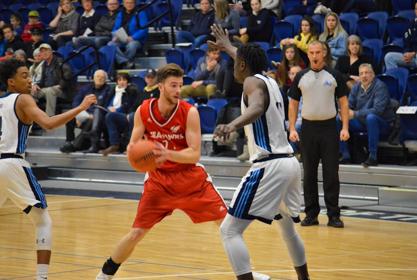 Despite losing twice to the St. Francis Xavier X-Men twice in weekend AUS men's basketball play in Antigonish, N.S., Nathan Barker (centre) and the Memorial Sea-Hawks still have clinched a berth in the conference playoffs. — St. FX Athletics/via Memorial Athletics