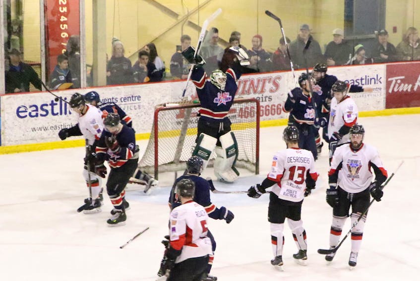 In this file photo, Conception Bay CeeBees goalie A.J. Whiffen raises his arms in celebration amid dejected members of the Clarenville Caribous at the final buzzer in Game 5 of the 2017 Herder Memorial Trophy provincial senior hockey championship in Clarenville. After sitting out last season when they were given the boot from the Avalon East Senior Hockey League by the other four teams, the CeeBees are back in senior hockey, in the Central-West Senior Hockey League.