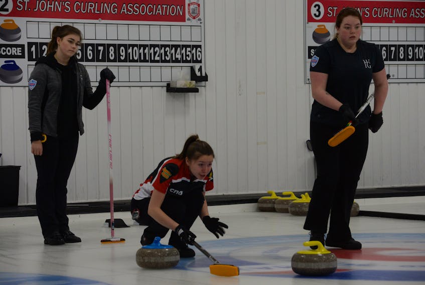 Third Sarah McNeil-Lamswood exhorts her team’s sweepers on a shot by skip Mackenzie Mitchell (not shown) during their game against the Emily Neary rink in the Newfoundland and Labrador junior curling championships at the Re/Max Centre in St. John’s Wednesday afternoon. Looking on are Neary (left) and her third, Felicity Snow. The Neary rink, out of the Re/Max Centre. defeated the Mitchell rink from Corner Brook 13-5.