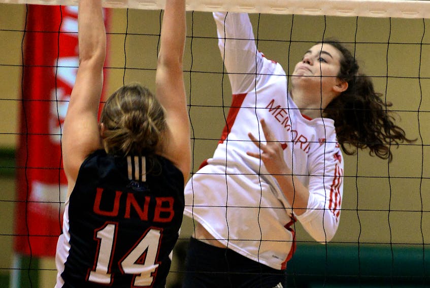 Emma Hackett of the Memorial Sea-Hawks spikes the ball over UNB Varsity Reds’ Adora Rooyakkers during AUS volleyball action at the MUN Field House Sunday.